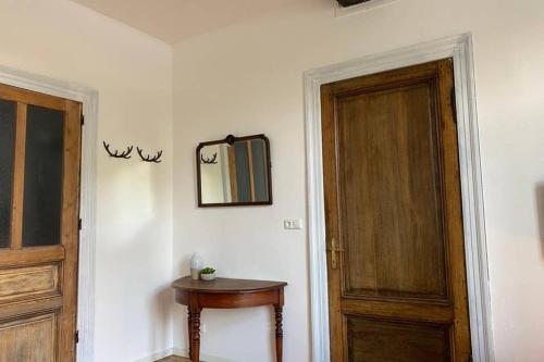 a room with a door and a table and a mirror at Authentic Stays - 6p-apartment in Eijsden
