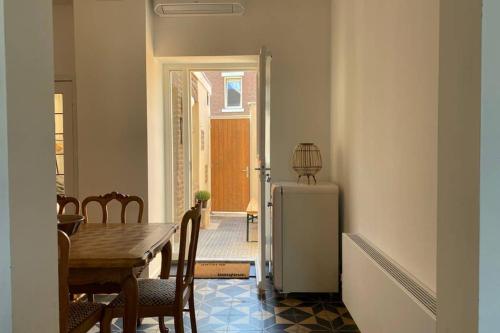 a dining room with a table and a refrigerator at Authentic Stays - 6p-apartment in Eijsden