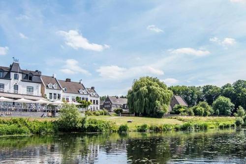 a view of a town with a river and houses at Authentic Stays - 6p-apartment in Eijsden