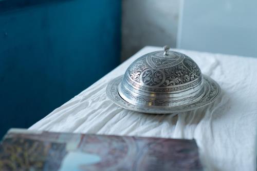 a silver tea pot sitting on top of a bed at Atilla's Cave Hotel in Nevsehir