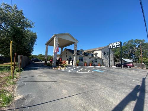 an empty parking lot with a gas station at Cedar Creek Inn in Bertram