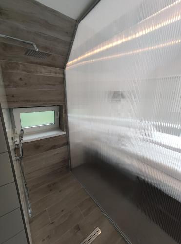 a shower stall with a window in a bathroom at 4 Seasons - House in Sub Cetate
