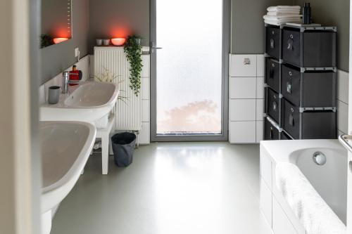 a bathroom with two sinks and a large window at London 993 Apt 202 in Antwerp