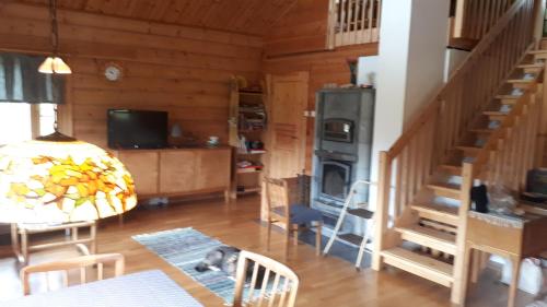 a dog laying on a table in a living room at Savutaival in Pello