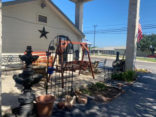 a playground in front of a building with a flag at Cedar Creek Inn in Bertram