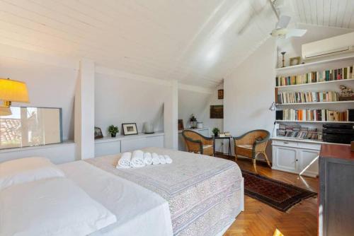a bedroom with a white bed and a book shelf at ֍ Splendido Attico - Arsenale - con Terrazza ֍ in Venice