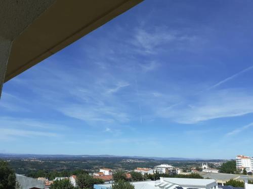 a view of a blue sky from a window at SEIA Alojamentos Leitao in Seia