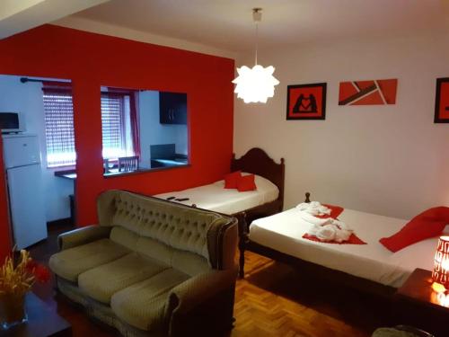 a living room with two beds and a couch at SEIA Alojamentos Leitao in Seia
