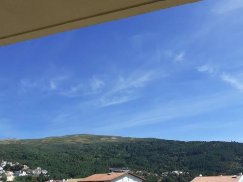 a view of a mountain from a window at SEIA Alojamentos Leitao in Seia