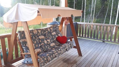 a porch swing with a couch on a deck at Savutaival in Pello