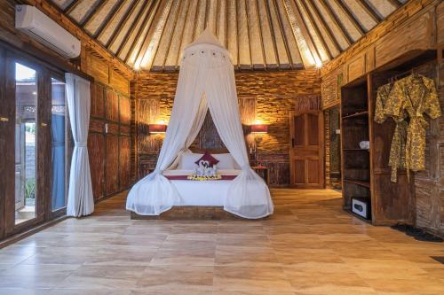a bedroom with a bed with a canopy at The Forest Villa Ubud in Ubud