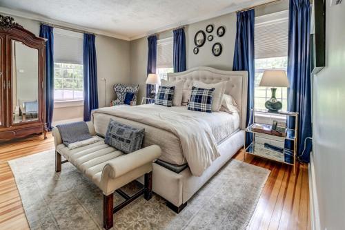 a bedroom with a large bed and a chair at Stagecoach Inn in Goshen