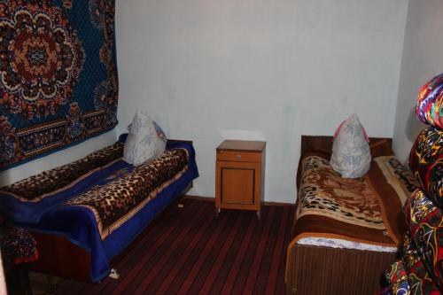 a small room with two beds and a table at Panorama in Arslanbob