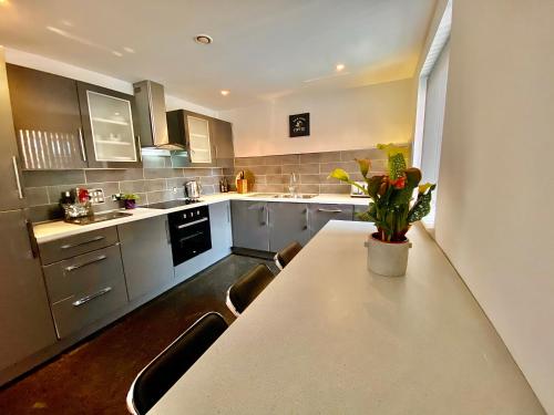 a kitchen with a table and some chairs in it at Liverpool city centre apartment on Duke Street in Liverpool
