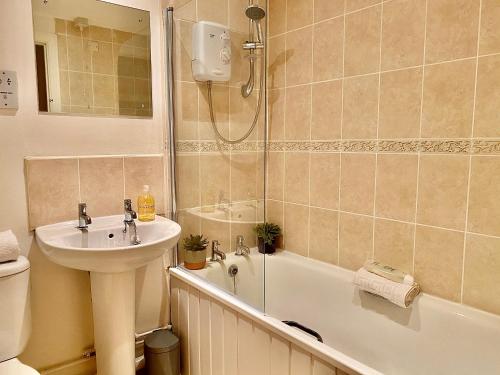 a bathroom with a sink and a toilet and a shower at Liverpool city centre apartment on Duke Street in Liverpool