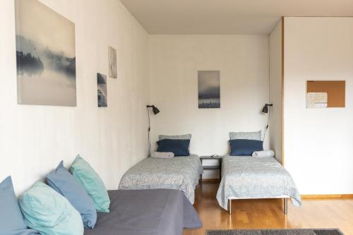a living room with two beds and a couch at Tuure´s studio near to Art Museum in Turku