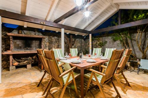 a dining room with a table and chairs and a fireplace at Holiday Home Rosko in Skradin