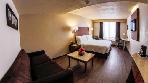 a hotel room with a bed and a couch at Holiday Inn Orizaba, an IHG Hotel in Orizaba