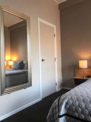 a bedroom with a bed and a mirror at Touchstone Hotel - City Center in San Francisco