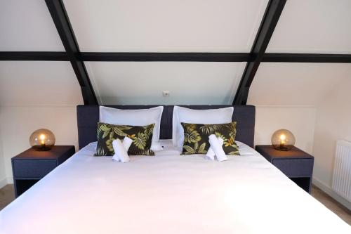 a bedroom with a large bed with two night stands at Fantastic 90m2 Two-Bedroom Apartment with Terrace - WA7B in Tiel
