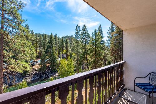 a balcony with a view of the woods at Alpine Rivers Inn in Leavenworth