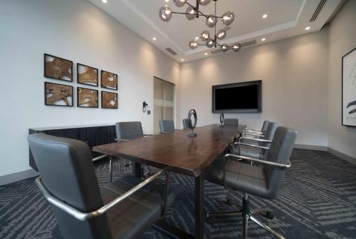 a conference room with a large wooden table and chairs at Holiday Inn Express - Boston Logan Airport - Revere by IHG in Revere