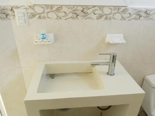 a white bathroom with a sink and a toilet at Hotel La Estrella Polar in Costa Esmeralda
