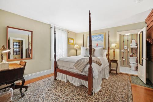 
a bedroom with a large bed and a large window at Martin House Inn in Nantucket
