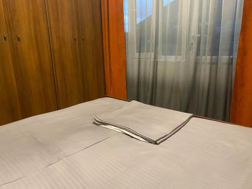 a fork sitting on a bed with a window at Golden Gate in Akhaltsikhe