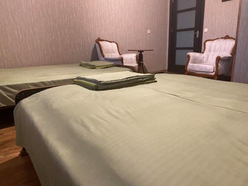 a hospital room with two beds and two chairs at Golden Gate in Akhaltsikhe
