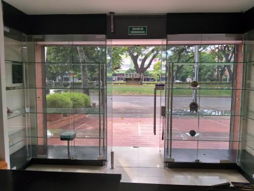 an open glass door with a view of a street at Pampalinda Hotel in Cali