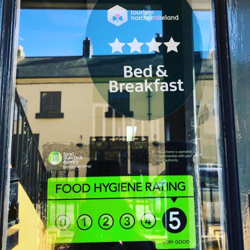 a sign in a window of a food hygiene rating at Dufferin Coaching Inn in Killyleagh