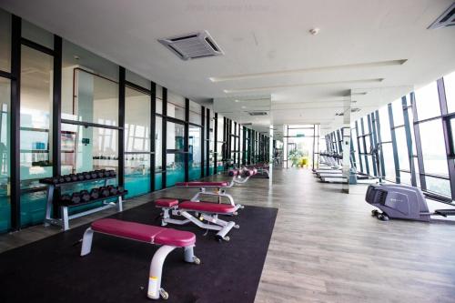 a gym with a row of exercise bikes and benches at Homybed Southkey Mosaic Homestay in Johor Bahru