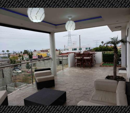 a patio with chairs and a table on a balcony at The Condo (by Modern Apartments) in Rosarito