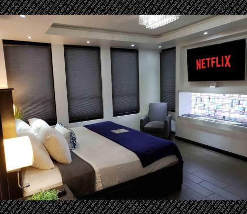 a bedroom with a king sized bed and a television at The Condo (by Modern Apartments) in Rosarito