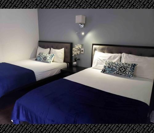 two beds in a room with blue and white at The Condo (by Modern Apartments) in Rosarito