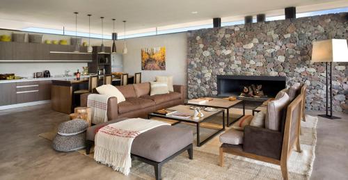 a living room with a couch and a fireplace at The Vines Resort & Spa in Los Sauces
