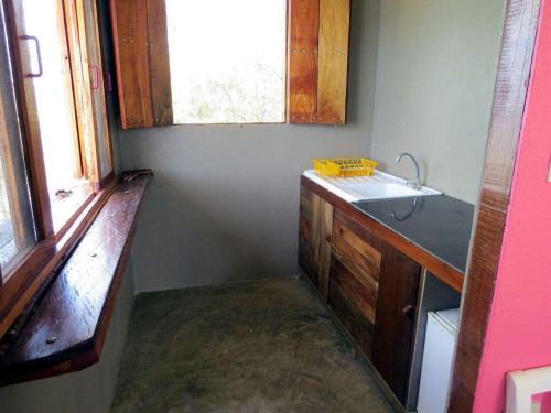 a small kitchen with a sink and a window at WINDOWS AT THE SEA in San Juanillo