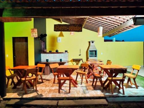 a group of tables and chairs in a restaurant at Pousada São Miguel dos Milagres in São Miguel dos Milagres