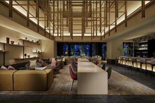 a lobby with couches and tables and a bar at Hyatt House Kanazawa in Kanazawa