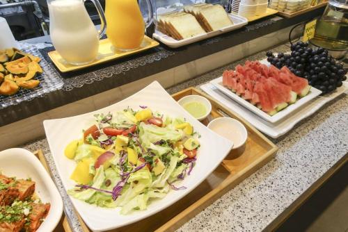 a buffet with two plates of food on a table at Stay Hotel in Gwangju