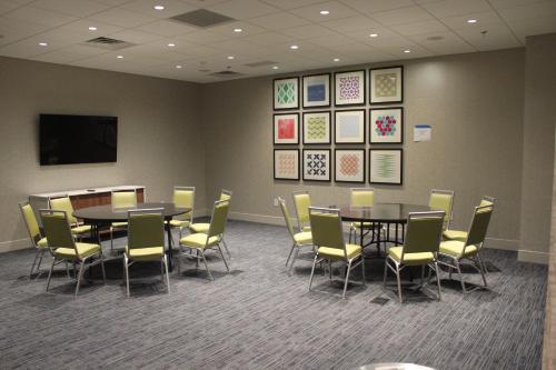 a conference room with tables and chairs and a tv at Holiday Inn Express Athens - University Area by IHG in Athens