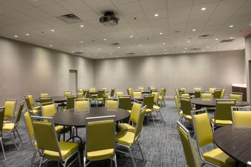 a conference room with tables and yellow chairs at Holiday Inn Express Athens - University Area by IHG in Athens