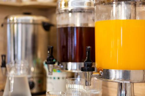 a jug of orange juice sitting on top of a counter at Végvár Spa Apartman in Gyula