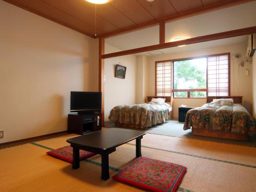 Postel nebo postele na pokoji v ubytování Star Hotel Akakura