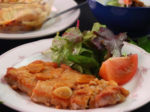 a plate of food with a salad and a piece of fish at Star Hotel Akakura in Myoko