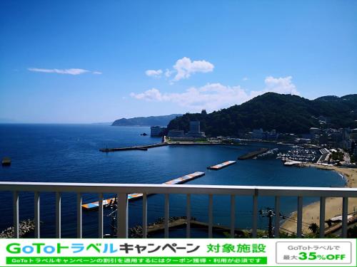 a view of a body of water with boats in it at Atami Onsen Guest House Megumi 5 minutes walk from Atami Station in Atami