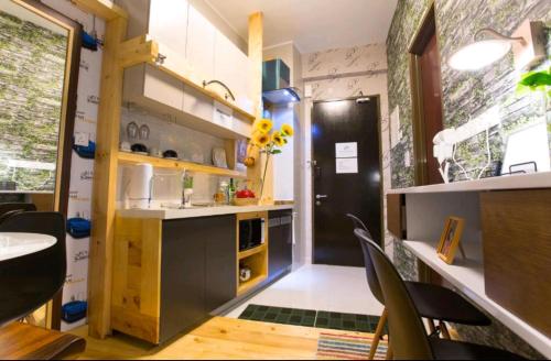 a kitchen with a black refrigerator and a table and chairs at Country Garden J Agape Homestay JB Couple Hotel in Johor Bahru