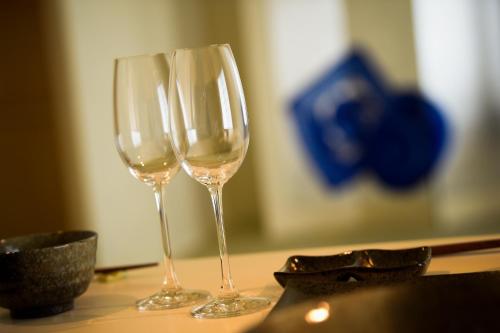 two wine glasses sitting on top of a table at Yuigahama 千世 in Kamakura