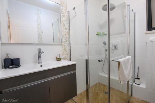 a bathroom with a sink and a shower at Lev Hahoresh Boutique Hotel in Shomera